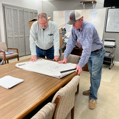 Staff inside of Fayetteville Lumber & Supply looking at blueprints